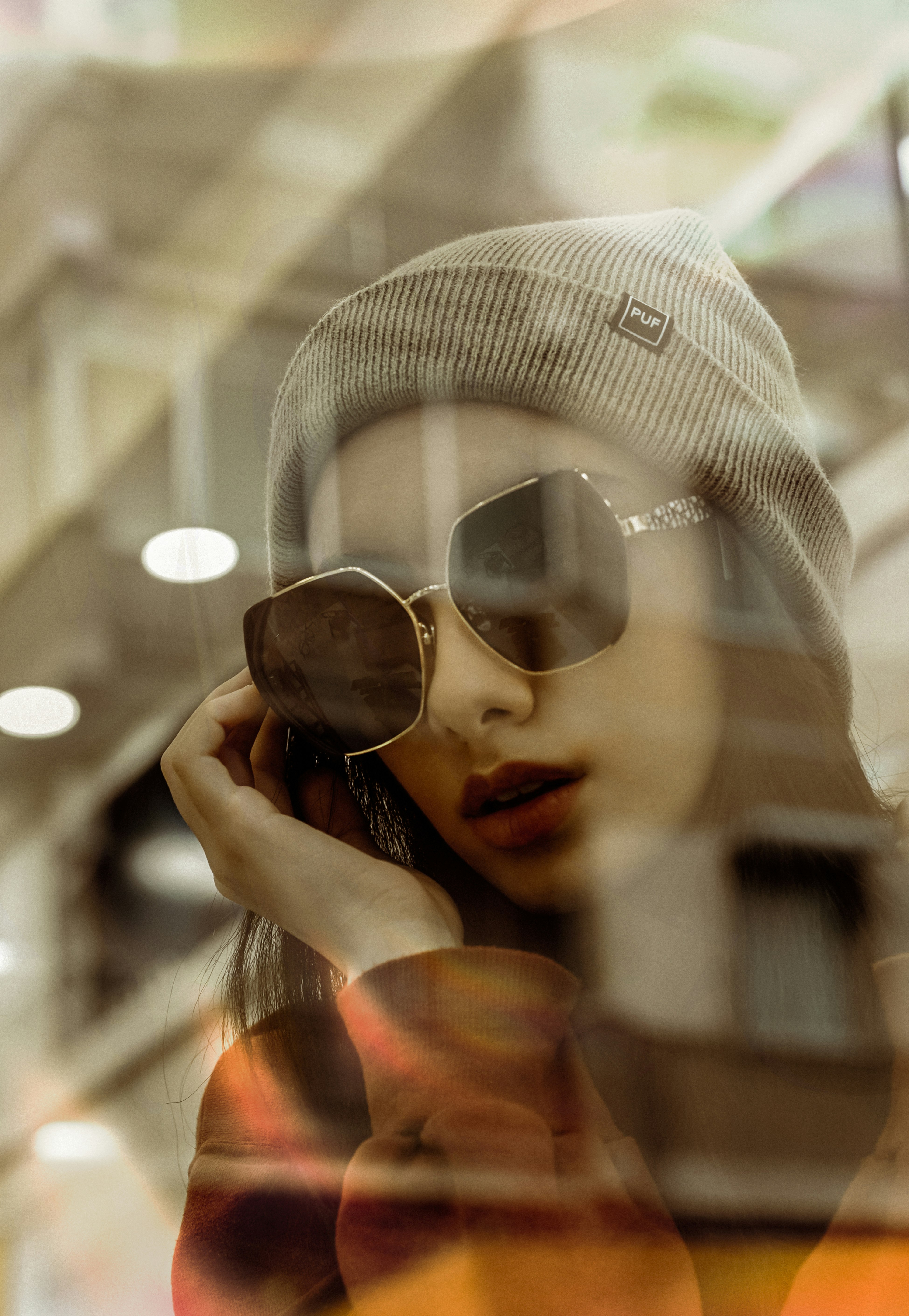 woman in white knit cap and black sunglasses